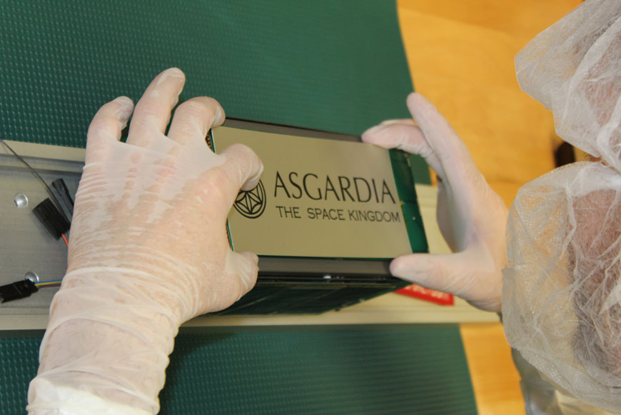 Спутник Asgardia-1, созданный американской компанией NanoRacks. На солнечные батареи спутника наносят гравировкой логотип и слоган Асгардии